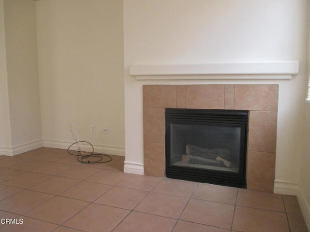 room details with a tiled fireplace and baseboards