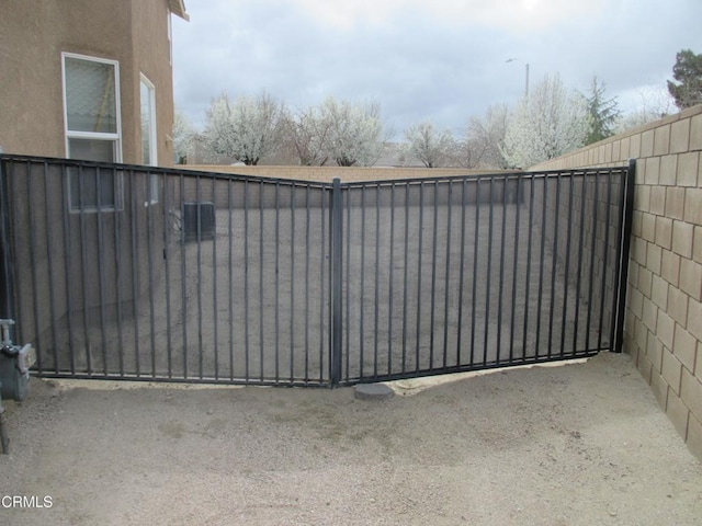 view of gate with fence