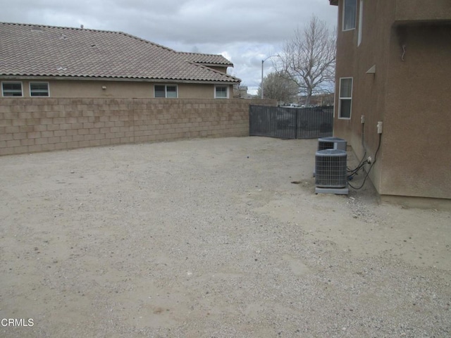 view of yard with cooling unit and fence