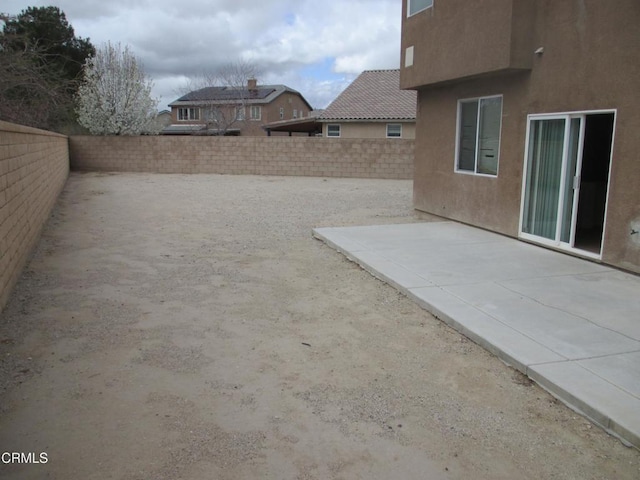 view of yard with a patio area and a fenced backyard