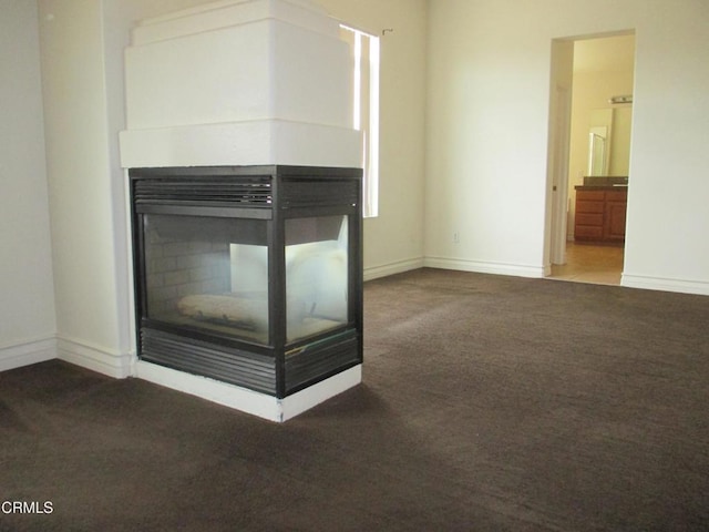 details with carpet, a multi sided fireplace, and baseboards