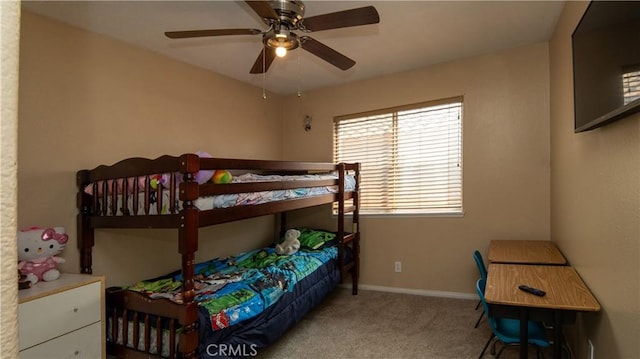 carpeted bedroom featuring a ceiling fan and baseboards