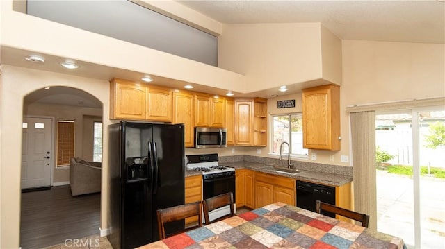 kitchen featuring high vaulted ceiling, open shelves, arched walkways, a sink, and black appliances