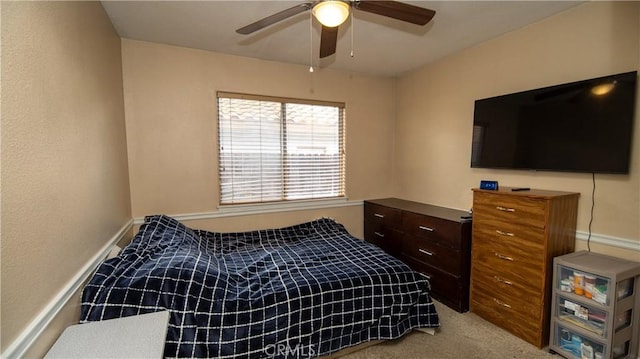 bedroom with baseboards, light colored carpet, and a ceiling fan