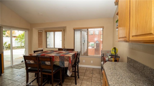 dining area with baseboards and lofted ceiling