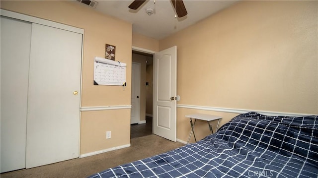 carpeted bedroom with a ceiling fan, baseboards, visible vents, and a closet