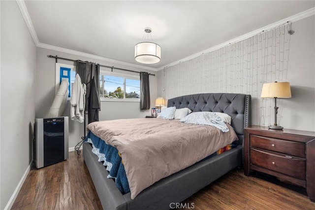 bedroom featuring ornamental molding, baseboards, and wood finished floors