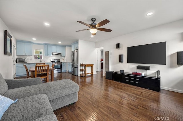 living room featuring recessed lighting, baseboards, a ceiling fan, and dark wood-style flooring