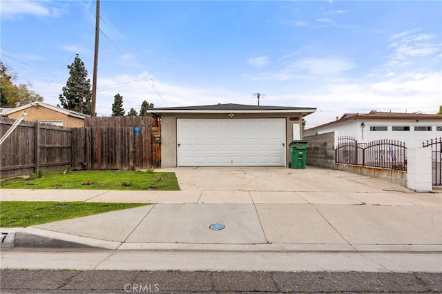 detached garage with a gate and fence