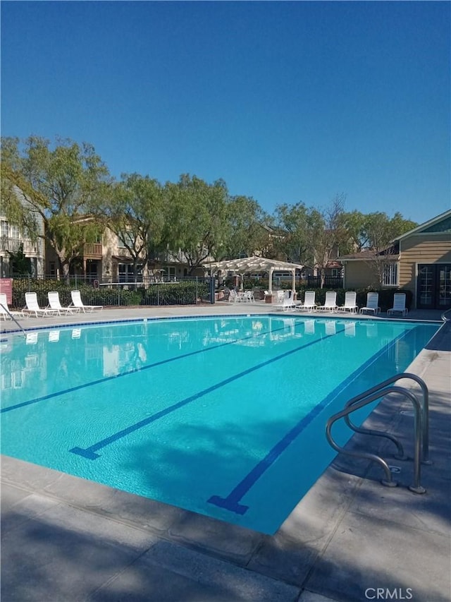 pool featuring a patio area and fence