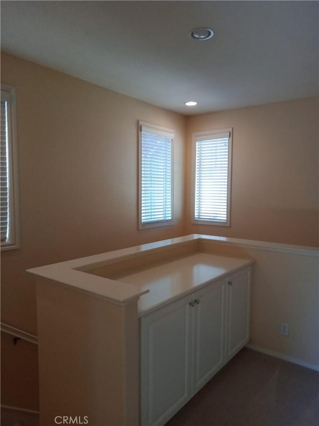 kitchen with recessed lighting and light colored carpet