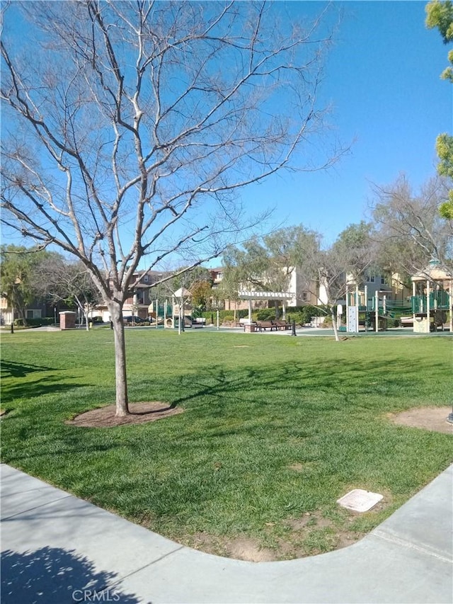 view of property's community with a lawn and a pergola