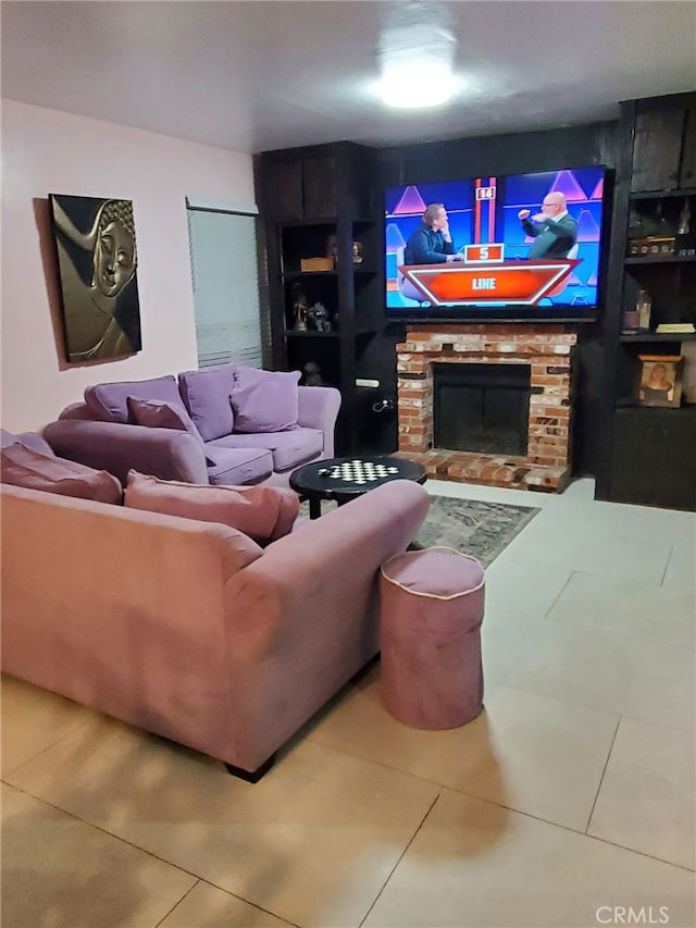 tiled living room featuring a stone fireplace