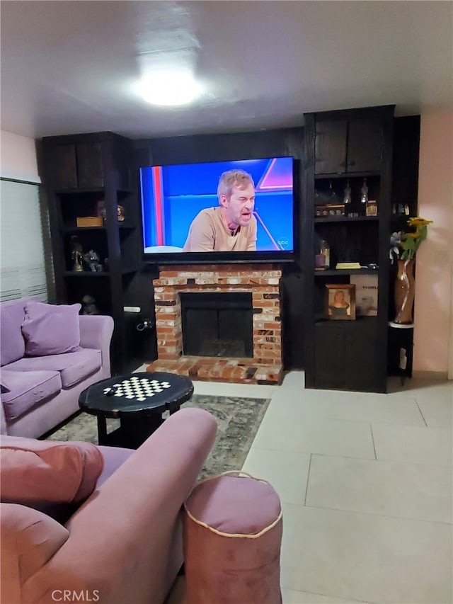 living room with a stone fireplace and tile patterned floors