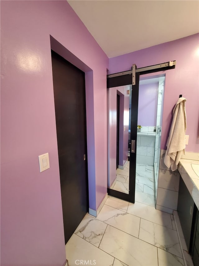 bathroom with vanity, baseboards, and marble finish floor