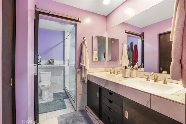 9920 Sepulveda Blvd Unit 1, Mission Hills San Fernando, CA 91345 - full bathroom featuring a shower stall, toilet, double vanity, tile walls, and a wainscoted wall