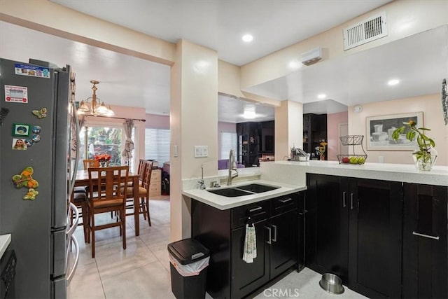 9920 Sepulveda Blvd Unit 1, Mission Hills San Fernando, CA 91345 - kitchen with freestanding refrigerator, a sink, dark cabinets, light countertops, and light tile patterned floors