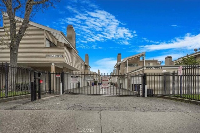 9920 Sepulveda Blvd Unit 1, Mission Hills San Fernando, CA 91345 - view of asphalt street with a gate and a gated entry