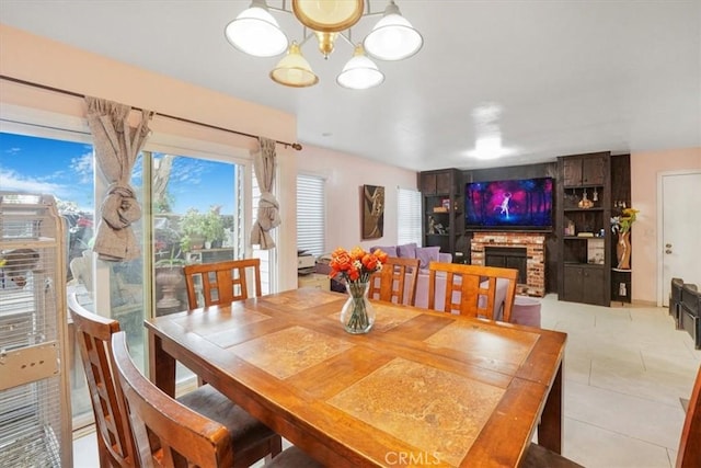 9920 Sepulveda Blvd Unit 1, Mission Hills San Fernando, CA 91345 - dining area featuring a fireplace, light tile patterned floors, and a chandelier