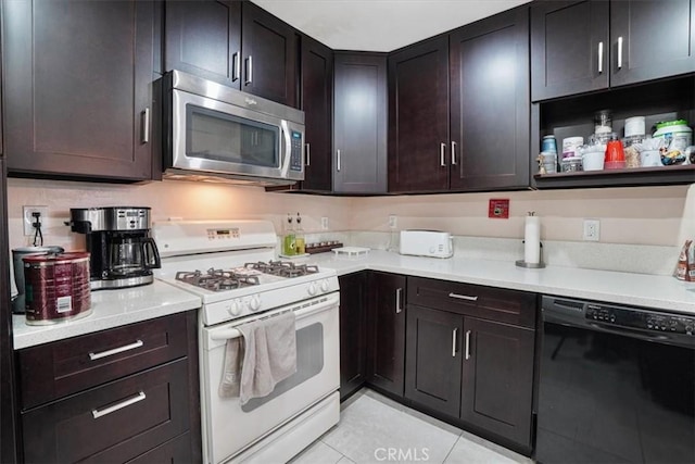 9920 Sepulveda Blvd Unit 1, Mission Hills San Fernando, CA 91345 - kitchen with stainless steel microwave, dishwasher, white gas range, light tile patterned flooring, and light countertops