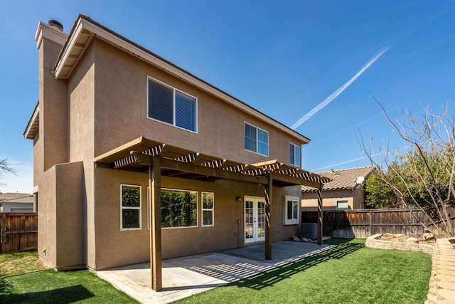 rear view of house with a pergola, french doors, fence, and a patio