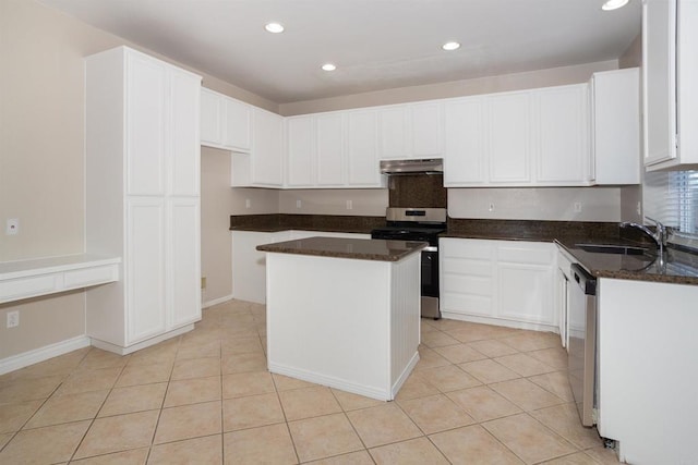 kitchen featuring under cabinet range hood, appliances with stainless steel finishes, a sink, and light tile patterned floors