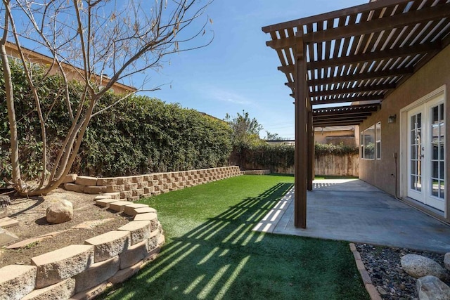 view of yard with a patio, french doors, a pergola, and a fenced backyard