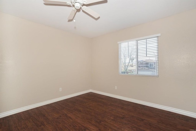 empty room with dark wood-type flooring, baseboards, and ceiling fan