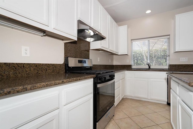 kitchen with stainless steel gas stove, a sink, under cabinet range hood, white cabinetry, and light tile patterned flooring