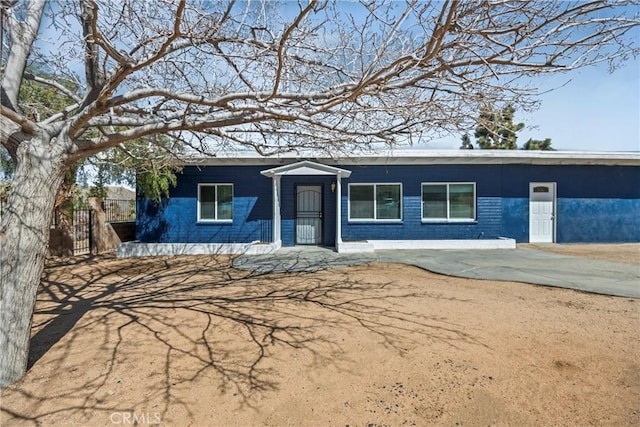 view of front of house featuring fence and brick siding