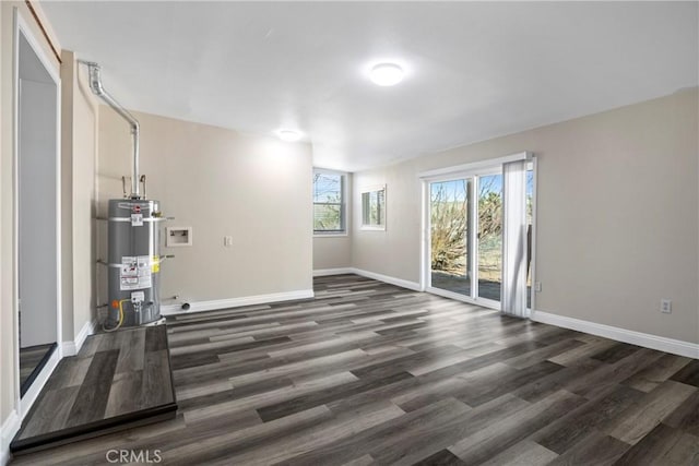 interior space featuring water heater, baseboards, and dark wood-style flooring