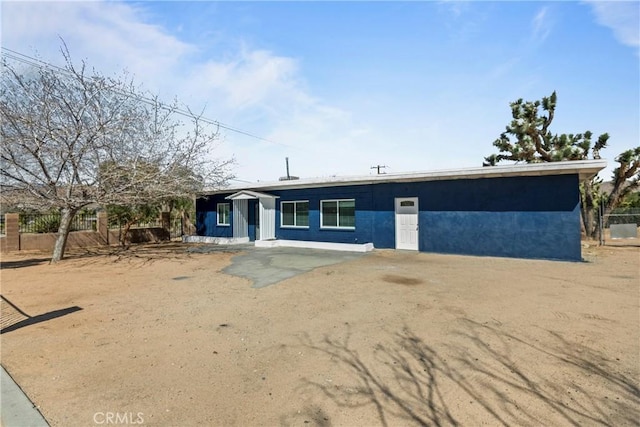 mid-century inspired home featuring fence