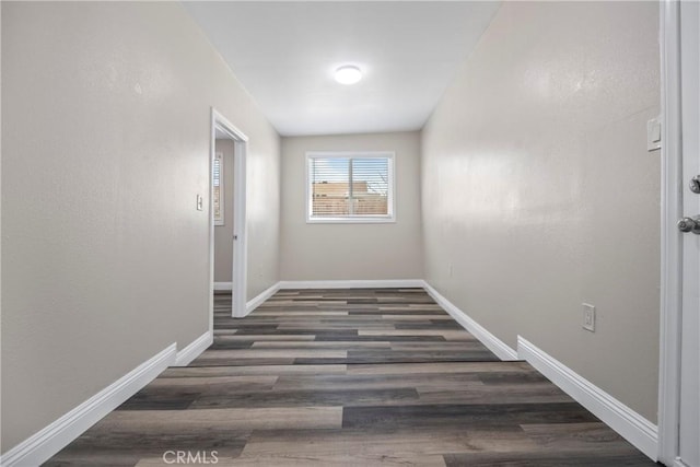 interior space with wood finished floors and baseboards