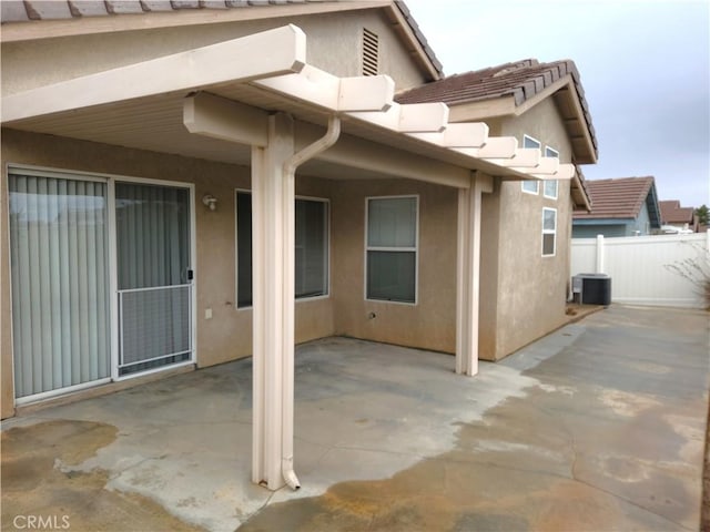 view of patio featuring central AC unit and fence