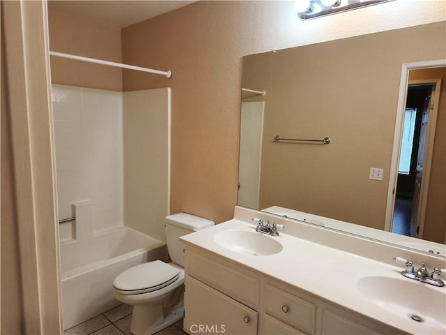 bathroom featuring a sink, toilet, double vanity, and tile patterned floors