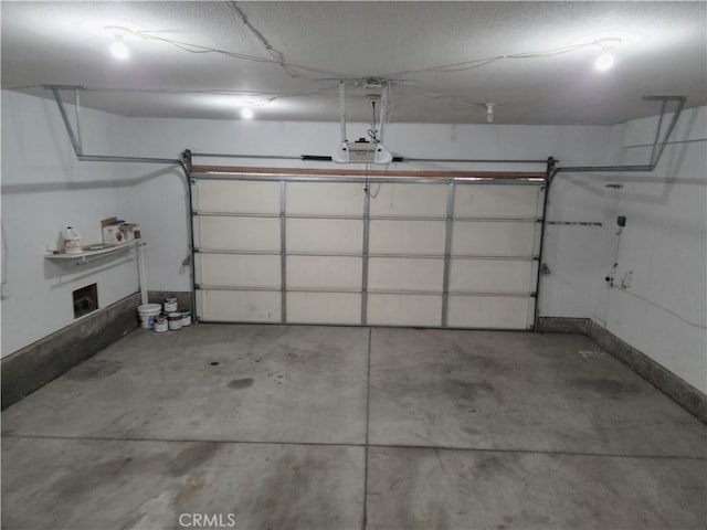 garage with a garage door opener and baseboards