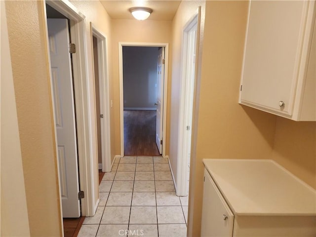 hallway with light tile patterned floors