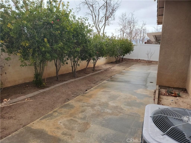 view of yard featuring central air condition unit, a patio, and a fenced backyard