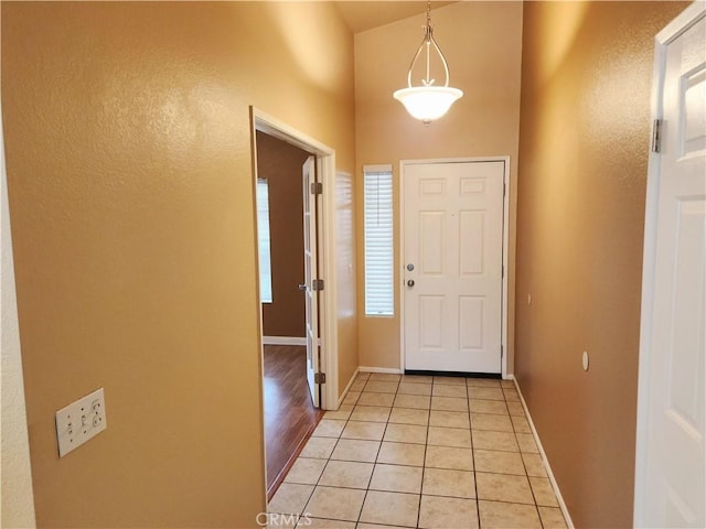 entrance foyer with light tile patterned flooring and baseboards