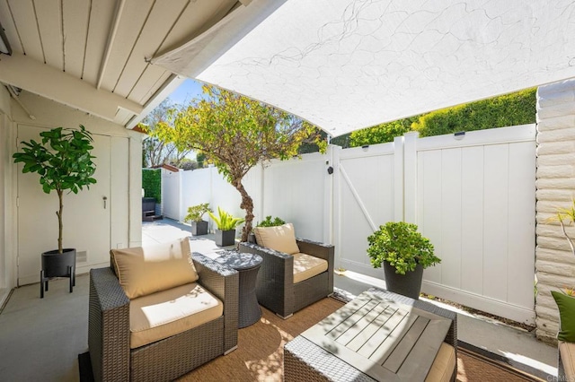 view of patio / terrace with outdoor lounge area, a gate, and a fenced backyard