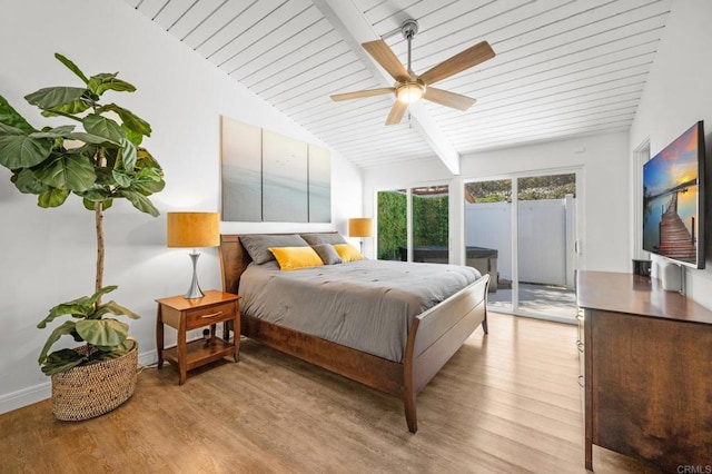 bedroom featuring lofted ceiling, access to outside, baseboards, and light wood finished floors