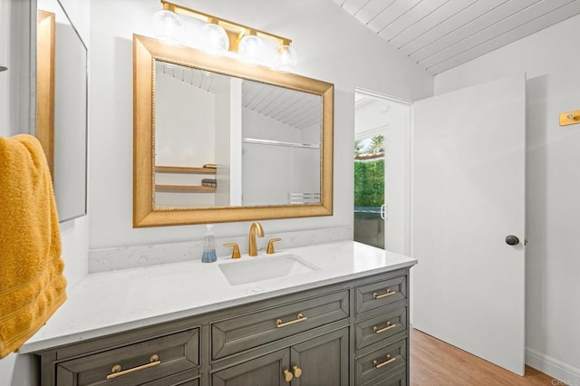 bathroom with wooden ceiling, lofted ceiling, wood finished floors, and vanity