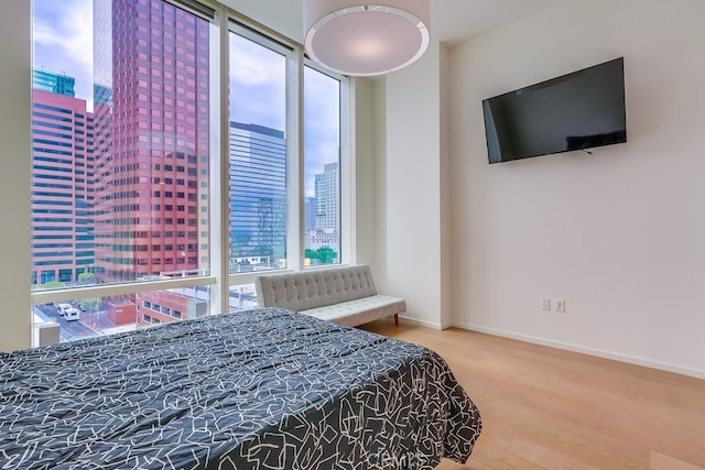 bedroom featuring wood finished floors and baseboards