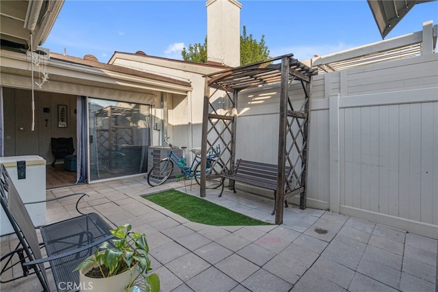 view of patio featuring central AC unit and a pergola