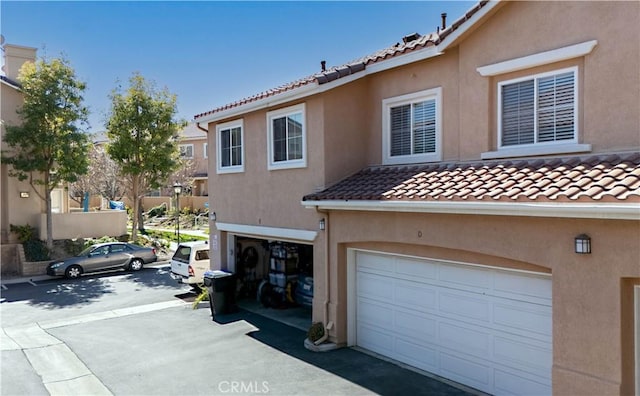 view of front of house with a tiled roof and stucco siding