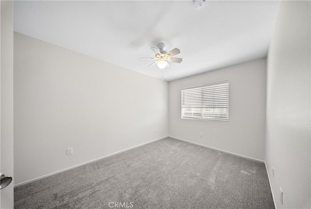 carpeted empty room with baseboards and ceiling fan