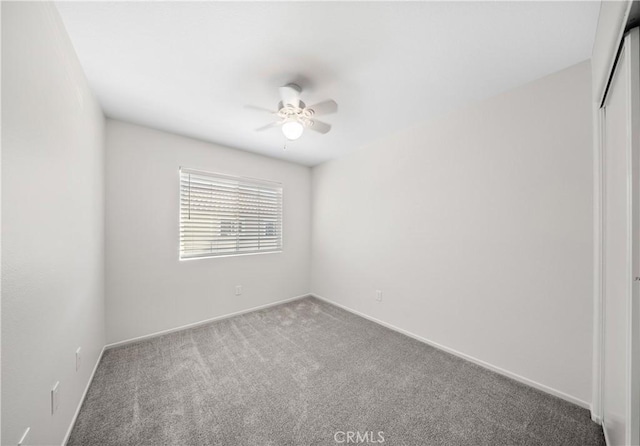 unfurnished room featuring baseboards, a ceiling fan, and carpet flooring