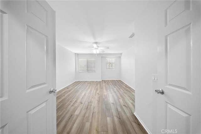 spare room with ceiling fan and wood finished floors