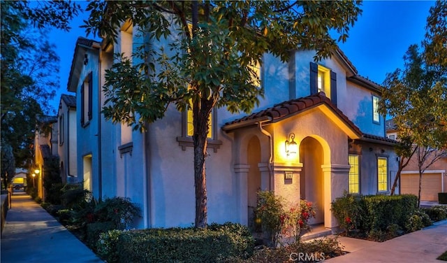 mediterranean / spanish-style home featuring stucco siding and a tile roof