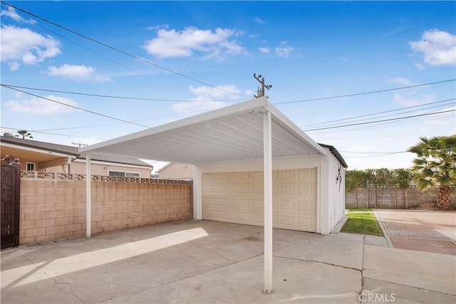 garage featuring a garage and fence